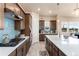 Modern kitchen with stainless steel appliances, quartz countertops, stylish backsplash, and ample cabinet space at 6657 S Kline Way, Littleton, CO 80127