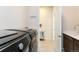 Laundry room boasts modern appliances, a utility sink, and convenient access at 6657 S Kline Way, Littleton, CO 80127