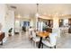Spacious living room featuring modern dining set with a kitchen island and barstool seating at 6657 S Kline Way, Littleton, CO 80127
