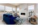 Cozy living room featuring a modern fireplace, large windows, stylish furniture and decor at 6657 S Kline Way, Littleton, CO 80127