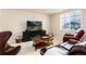 Inviting living room with a cozy fireplace, TV, and comfortable seating area at 6657 S Kline Way, Littleton, CO 80127