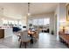 Open concept dining room extending into the living room with lots of natural light and fireplace at 6657 S Kline Way, Littleton, CO 80127
