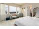 Bright main bedroom with large windows, sitting area, and an ensuite bathroom at 6657 S Kline Way, Littleton, CO 80127