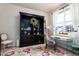 Stylish office space features a large bookshelf, desk, and natural light at 6657 S Kline Way, Littleton, CO 80127