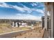 This view from the patio showcases suburban homes, a golf course and mountain views at 6657 S Kline Way, Littleton, CO 80127