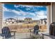 Inviting patio area featuring blue Adirondack chairs with a lovely view of the neighborhood at 6657 S Kline Way, Littleton, CO 80127