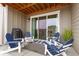 Undercover patio with a grill, seating, and sliding glass doors at 6657 S Kline Way, Littleton, CO 80127
