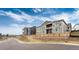 Charming homes with balconies featuring pristine landscaping and natural wood privacy fences at 6657 S Kline Way, Littleton, CO 80127