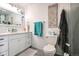 Bright bathroom with white cabinets, stylish mirror, and seaside themed decor at 16921 W 60Th Dr, Arvada, CO 80403