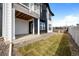 Modern townhome exterior showcasing a covered patio, black accents, and a well-maintained lawn at 8242 S Pierson St, Littleton, CO 80127