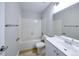 Bright bathroom features a white tub, tiled shower and white sink with storage at 8034 Decatur St, Westminster, CO 80031