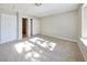Bright bedroom with neutral carpet, a large window, and closet for storage at 8034 Decatur St, Westminster, CO 80031