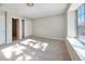 Bright bedroom with neutral carpet, a large window, and closet for storage at 8034 Decatur St, Westminster, CO 80031