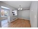 Open dining area with hardwood floors, chandelier, and a view into the kitchen at 8034 Decatur St, Westminster, CO 80031