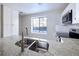 Bright kitchen featuring stainless steel appliances, white cabinets, and granite countertops at 8034 Decatur St, Westminster, CO 80031