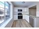Well-lit kitchen featuring stainless steel appliances, white cabinets, granite countertops, and a window at 8034 Decatur St, Westminster, CO 80031