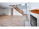 Spacious living room featuring light hardwood floors, fireplace, and a staircase at 8034 Decatur St, Westminster, CO 80031