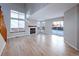 Spacious living room with light hardwood floors, fireplace, and sliding doors leading to patio at 8034 Decatur St, Westminster, CO 80031