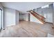 Bright and open living room showing light hardwood floors, staircase, and entrance to dining room at 8034 Decatur St, Westminster, CO 80031