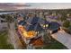 Aerial view of a luxury home with a large deck, well-kept landscaping, and an attached garage at 5602 Silver Bluff Ct, Parker, CO 80134