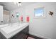Modern bathroom featuring floating vanity, chrome faucets, and neutral walls at 5602 Silver Bluff Ct, Parker, CO 80134