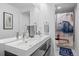 Contemporary bathroom with a double sink vanity and shower with a patterned curtain at 5602 Silver Bluff Ct, Parker, CO 80134
