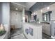Modern bathroom with a glass shower, double sinks, and stylish gray tiling at 5602 Silver Bluff Ct, Parker, CO 80134