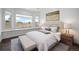 Serene bedroom with a window view, upholstered headboard, and stylish decor at 5602 Silver Bluff Ct, Parker, CO 80134