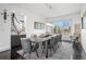 Modern dining room featuring a sleek table, unique light fixture and scenic views at 5602 Silver Bluff Ct, Parker, CO 80134