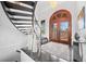 Elegant home entryway showcasing a curved staircase, hardwood floors, and a custom front door at 5602 Silver Bluff Ct, Parker, CO 80134