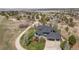 Aerial view of a home featuring a lush green lawn, circular driveway, and mature landscaping at 5602 Silver Bluff Ct, Parker, CO 80134