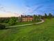 Exterior view of luxurious home with a long driveway at 5602 Silver Bluff Ct, Parker, CO 80134