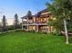 Stunning multi-story home featuring a spacious porch and beautifully landscaped yard with mature trees at 5602 Silver Bluff Ct, Parker, CO 80134