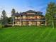 Stunning multi-story home featuring a spacious porch and beautifully landscaped yard with mature trees at 5602 Silver Bluff Ct, Parker, CO 80134