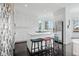 Bright kitchen featuring a center island with seating, white cabinets and stainless appliances at 5602 Silver Bluff Ct, Parker, CO 80134