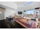 Open-concept living space with a fireplace, hardwood floors, and modern decor at 5602 Silver Bluff Ct, Parker, CO 80134