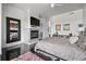 Inviting main bedroom featuring a fireplace, hardwood floors, area rug, and a large mirror for added style at 5602 Silver Bluff Ct, Parker, CO 80134