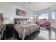 Bright main bedroom boasts dark hardwood floors, area rug, seating, and ample natural light from large windows at 5602 Silver Bluff Ct, Parker, CO 80134