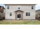 Exterior view of a home's backyard with a well-maintained lawn and access to the house at 12715 E 104Th Pl, Commerce City, CO 80022