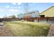 Spacious backyard with a well-maintained lawn, fire pit, and wood fence at 12715 E 104Th Pl, Commerce City, CO 80022