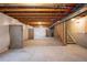 Unfinished basement with concrete floor, insulated walls, exposed ceiling with staircase at 12715 E 104Th Pl, Commerce City, CO 80022