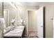 Bathroom featuring double sink vanity and neutral colored walls at 12715 E 104Th Pl, Commerce City, CO 80022