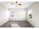 Bedroom with two windows and neutral carpeting, providing natural light and a cozy atmosphere at 12715 E 104Th Pl, Commerce City, CO 80022