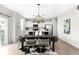 Bright dining area featuring modern lighting, stylish decor, and an open connection to the kitchen at 12715 E 104Th Pl, Commerce City, CO 80022