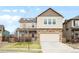 Two-story home with stone accents, a well-manicured lawn, and a two-car garage for convenient parking at 12715 E 104Th Pl, Commerce City, CO 80022