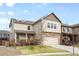 Two-story home with neutral siding, stone accents, and a well-maintained front yard at 12715 E 104Th Pl, Commerce City, CO 80022