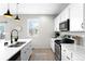 Kitchen featuring stone counters and stainless appliances at 12715 E 104Th Pl, Commerce City, CO 80022