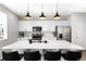 Island kitchen featuring stone countertops, pendant lighting, stainless appliances, and seating at 12715 E 104Th Pl, Commerce City, CO 80022