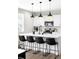 Kitchen featuring an island with seating and stainless steel appliances at 12715 E 104Th Pl, Commerce City, CO 80022