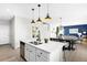 Kitchen area with an island that features seating and views of the dining and living areas at 12715 E 104Th Pl, Commerce City, CO 80022